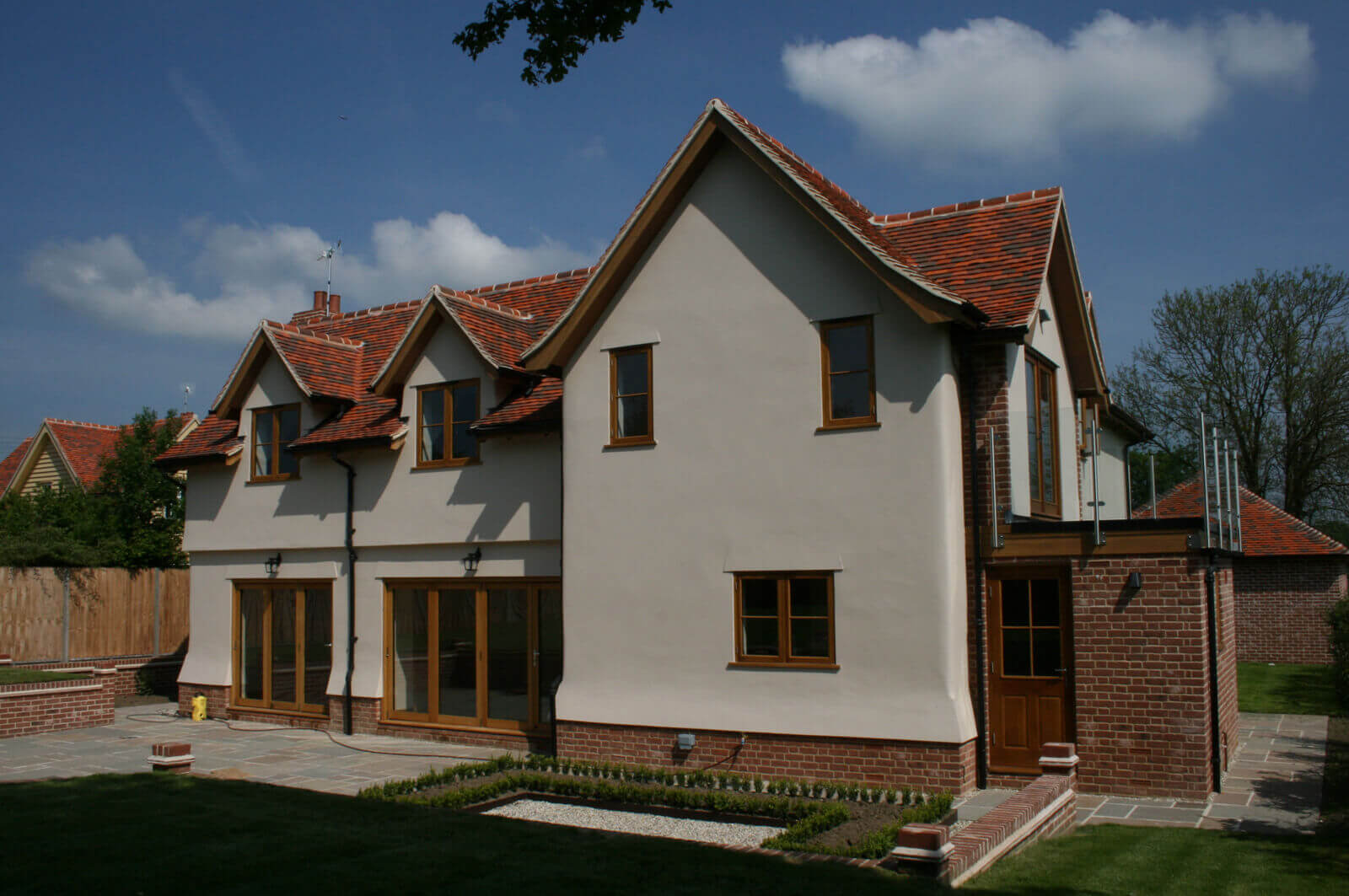 Back view of house showing garden and side balcony.